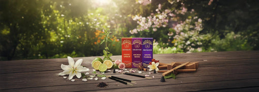Premium incense sticks with floral and citrus decor on a wooden table outdoors