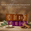 Incense stick burning in holder with boxes of Mystic Sandal and Sacred Wood premium masala incense, sandalwood and wood pieces, and green leaves on a neutral background.