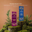 Sacred Wood and Rose Oudh premium incense sticks displayed on mossy wood with green ferns.