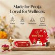 Red Wish Tree matti pal incense cups packaging on table with lit diya, flower petals, and incense smoke, ideal for prayer, yoga, meditation, and home ambience.
